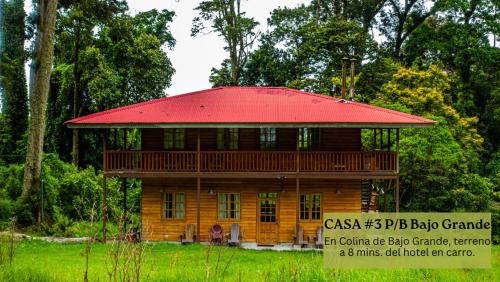 a large wooden house with a red roof at Los Quetzales Ecolodge & Spa in Cerro Punta