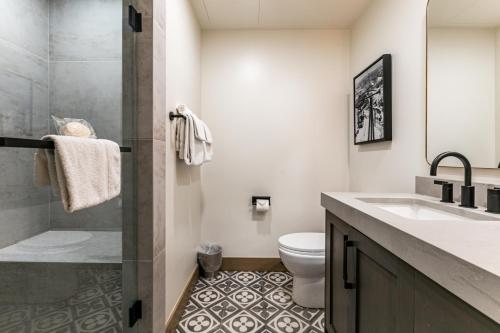 a bathroom with a toilet and a sink and a shower at Condos at Canyons Resort by White Pines in Park City