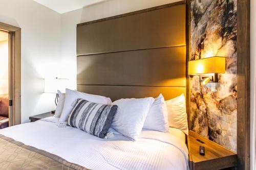 a bedroom with a bed with a large headboard at Condos at Canyons Resort by White Pines in Park City