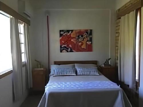 Postel nebo postele na pokoji v ubytování Entre a Mata Atlântida e o mar, quase pé na areia