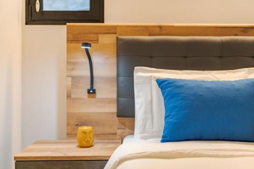 a bedroom with a bed with a blue pillow and a lamp at Oxford apartment Alpine escape villa in Eiras Velhas