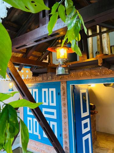 a blue door with a lamp on top of it at Airport Accommodation in Maduwa