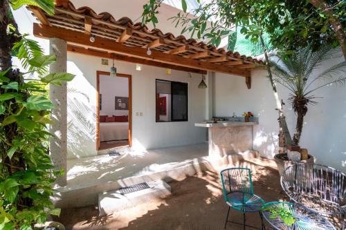 a patio of a house with two chairs and a table at Hotel Villa Mozart y Macondo in Puerto Escondido