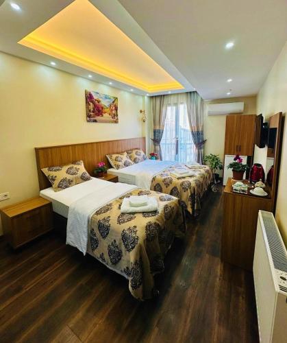 a hotel room with two beds and a television at Hotel By Historia in Istanbul