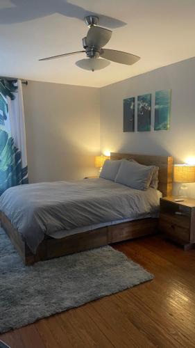 a bedroom with a bed with a ceiling fan at Habersham Hideaway in Savannah