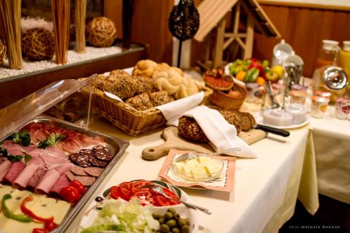 a table with a buffet of different types of food at Hotel-Restaurant-Haus Berger in Viersen