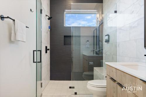 a bathroom with a shower and a toilet and a sink at New Build 2BR 2BA Steiner Ranch Stay w Balcony Dining by Austin Vacay in Austin