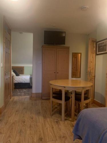 a room with a table and a bedroom with a bed at Kate's Rest in Kilkenny