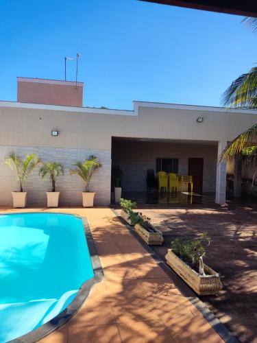 a swimming pool in front of a building at Rancho Costa in Pereira Barreto