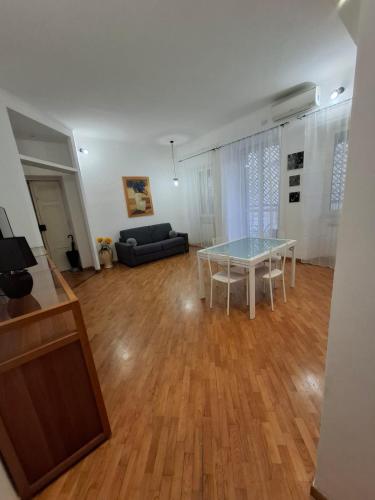 a living room with a table and a couch at Casa Mare Roma in Lido di Ostia