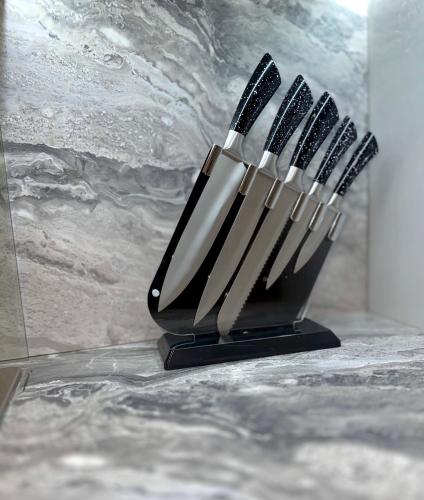a group of toothbrushes in a holder on a counter at Luxxe House with Hot tub and Pool table in Uxbridge