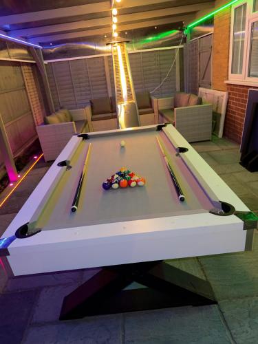 a pool table with cue balls on top of it at Luxxe House with Hot tub and Pool table in Uxbridge