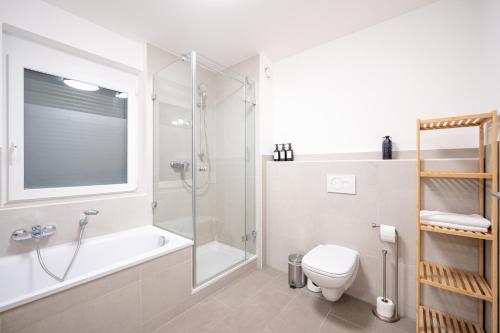 a bathroom with a shower and a toilet and a sink at LIBORIA: Stylisches Haus; Sauna ; 4min zum See in Seehausen am Staffelsee