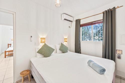 Postel nebo postele na pokoji v ubytování TUK Tropical Boutique Resort Jan Thiel