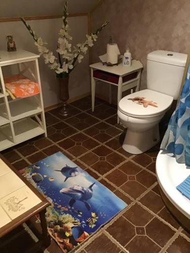 a bathroom with a toilet and a sink at Šturmų Sodyba in Ventė