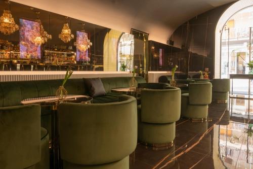 a restaurant with chairs and tables and a bar at Bra Hotel in Bari