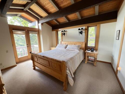 a bedroom with a large bed in a room with windows at Sun West Lodge in Grahams Place