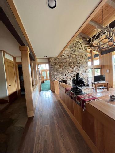 a kitchen with a counter and a stone wall at Sun West Lodge in Grahams Place