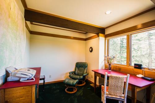 a room with a desk and a chair and a table at Sun West Lodge in Grahams Place