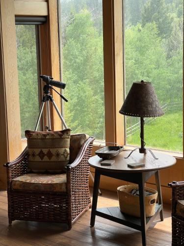 a room with a chair and a table with a lamp at Sun West Lodge in Grahams Place