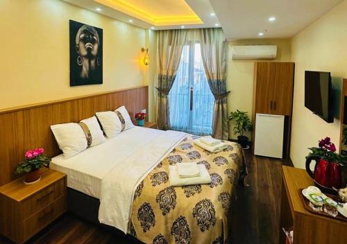 a bedroom with a large bed and a window at Hotel By Historia in Istanbul