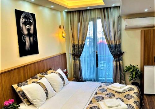 a bedroom with a large bed with a window at Hotel By Historia in Istanbul