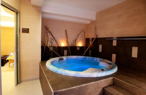 a bathroom with a large tub in a room at 'A Nuciara Park Hotel & Spa in Furci Siculo