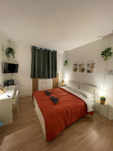 a bedroom with a large bed with a red blanket at Home In Town - Home in City Life near San Siro Stadium in Milan