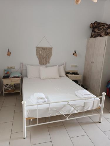 a bedroom with a white bed in a room at Theofanis Studios in Agia Anna Naxos