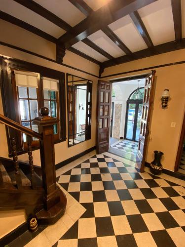 a room with a checkered floor and a staircase at Hotel Boutique Calash in Mar del Plata