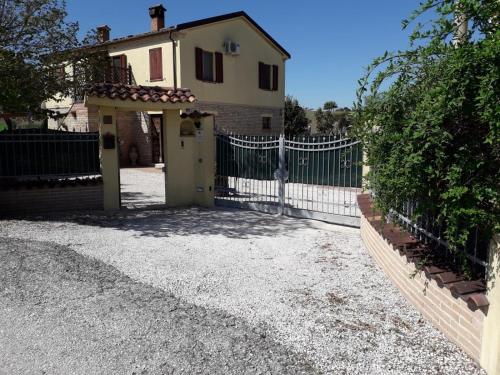a gate in front of a house with a fence at Casa Silos in Arcevia