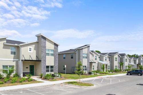 a row of apartment buildings with a parking lot at Lakeview 5BR with Game Room and Pool, Near Disney in Kissimmee