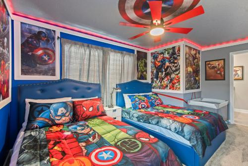 a bedroom with a superhero themed bed and a ceiling fan at Lakeview 5BR with Game Room and Pool, Near Disney in Kissimmee