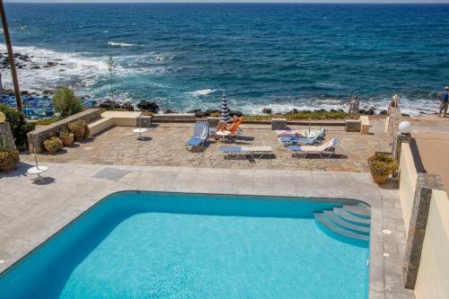 a swimming pool with a view of the ocean at Porto Sisi Hotel Apartments in Sissi