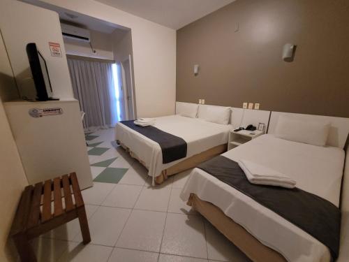 Katil atau katil-katil dalam bilik di Sandrin Praia Hotel