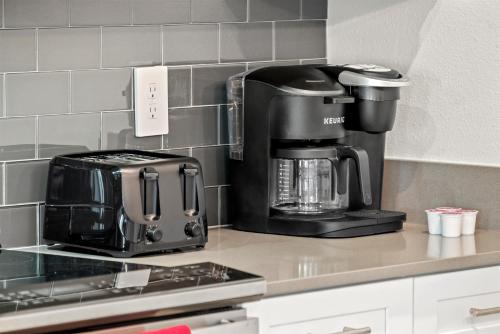 a coffee maker sitting on a counter in a kitchen at Lakeview 5BR with Game Room and Pool, Near Disney in Kissimmee