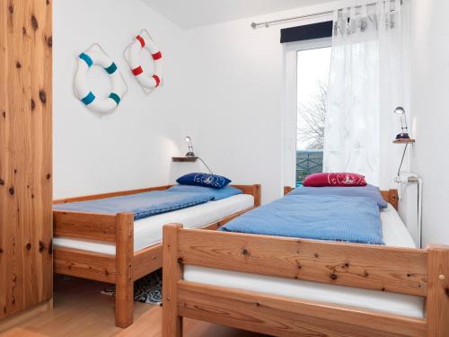 Ένα ή περισσότερα κρεβάτια σε δωμάτιο στο Ostsee Residenz Meeresblick Strandmuschel