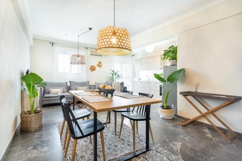 a dining room and living room with a table and chairs at Chania Urban Living - Live like a local in Chania Town