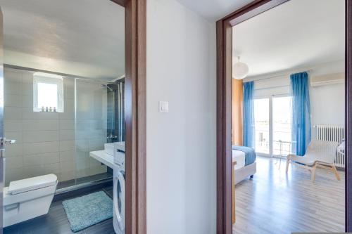 a bathroom with a sink and a mirror and a room at Chania Urban Living - Live like a local in Chania Town