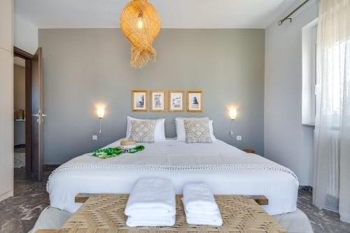 a bedroom with a large white bed with two pillows at Chania Urban Living - Live like a local in Chania Town