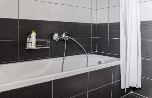 a bath tub with a faucet in a bathroom at Chania Urban Living - Live like a local in Chania Town