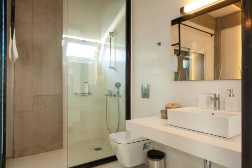 a bathroom with a toilet and a sink and a shower at Chania Urban Living - Live like a local in Chania Town