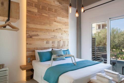 a bedroom with a white bed with a wooden wall at Chania Urban Living - Live like a local in Chania Town
