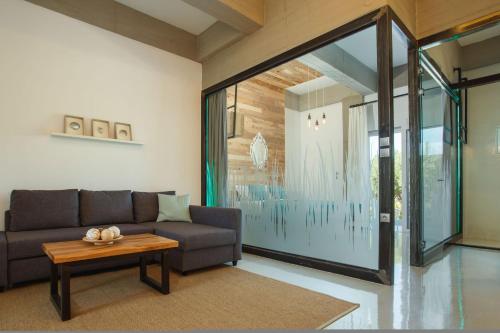a living room with a couch and a table at Chania Urban Living - Live like a local in Chania Town