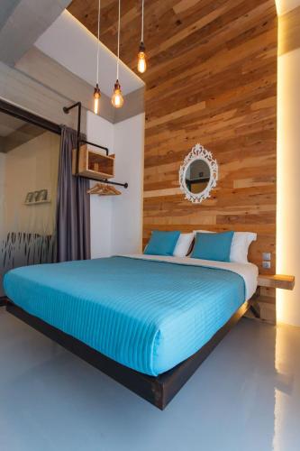 a bedroom with a bed with a wooden wall at Chania Urban Living - Live like a local in Chania Town