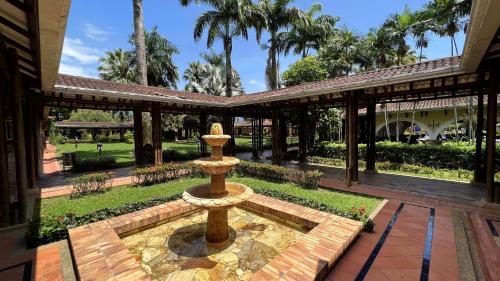 a fountain in the courtyard of a house at Tequendama Hotel Campestre Villavicencio in Villavicencio