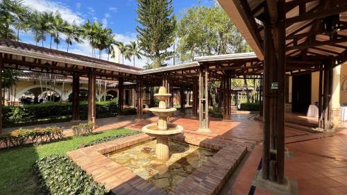 a fountain in the middle of a courtyard at Tequendama Hotel Campestre Villavicencio in Villavicencio