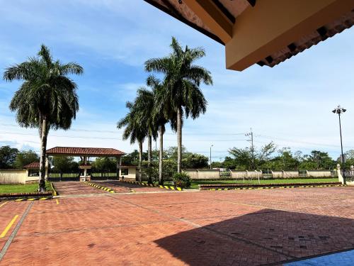 a basketball court with palm trees in a park at Tequendama Hotel Campestre Villavicencio in Villavicencio