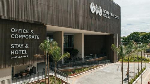 a building with a sign that reads office and corporate stay and hotel at WTC Goiânia Stay & Hotel by Atlantica in Goiânia