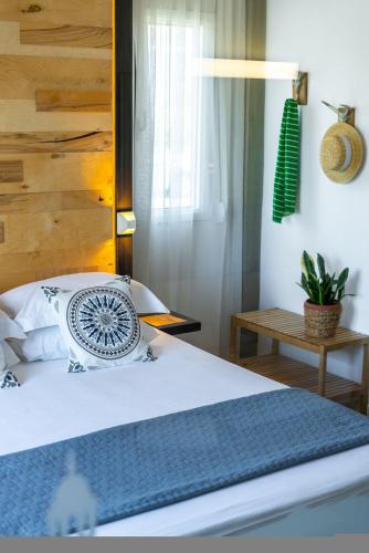 a bedroom with a bed with a pillow and a table at Chania Urban Living - Live like a local in Chania Town